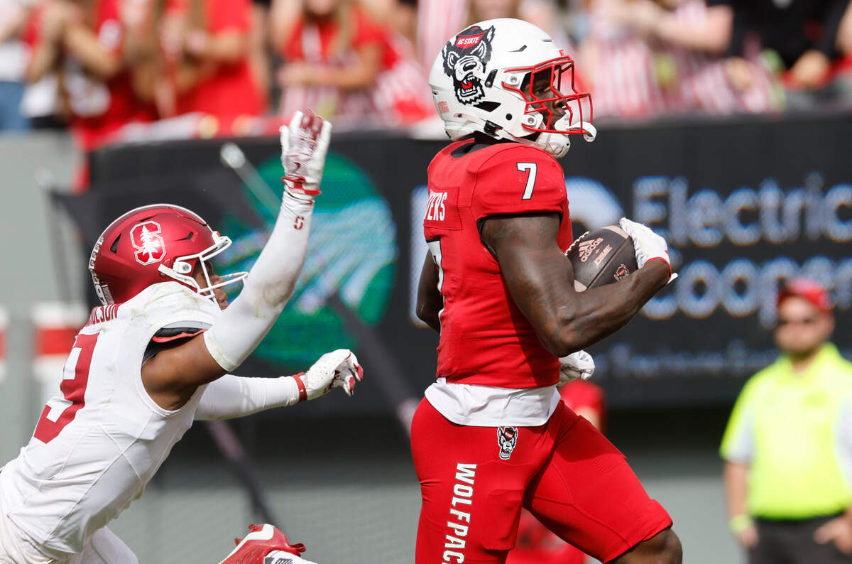 N.C. State running back Jordan Waters (7) beats Stanford cornerback Brandon Nicholson (9) to score on a 94-yard touchdown run during the second half of N.C. State’s 59-28 victory over Stanford at Carter-Finley Stadium in Raleigh, N.C., Saturday, Nov. 2, 2024.