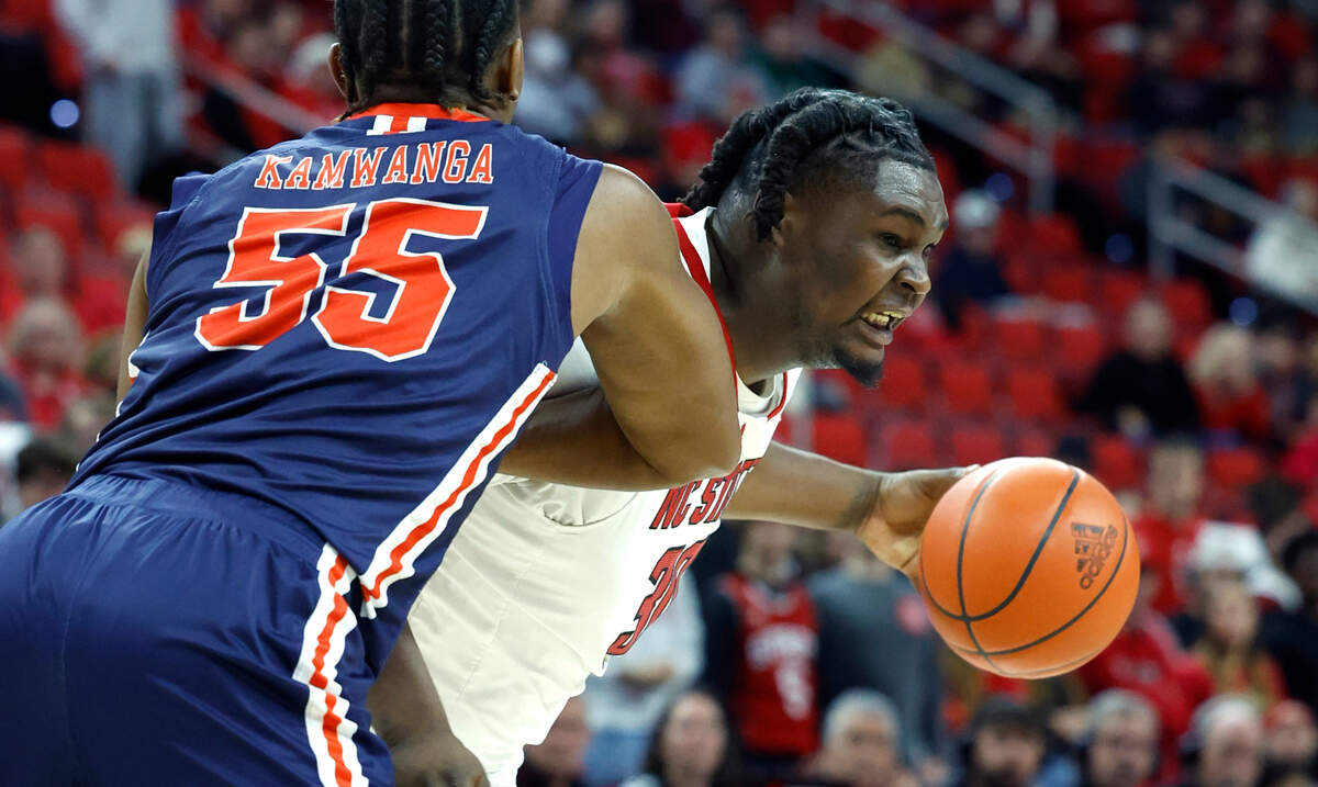 N.C. State’s DJ Burns Jr. (30) drives around UT Martin’s David Kamwanga (55) during the first half of N.C. State’s game against UT Martin at PNC Arena in Raleigh, N.C., Tuesday, Dec. 12, 2023.