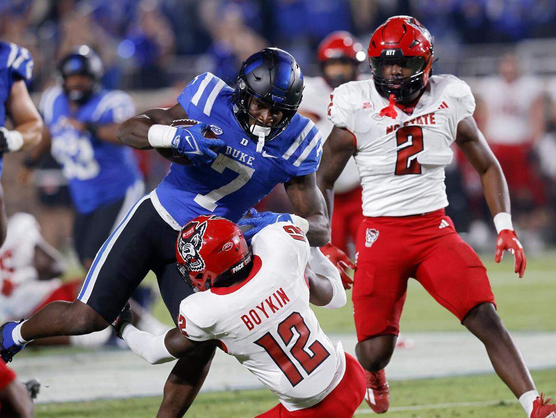 Duke’s Jordan Waters runs the ball under pressure from N.C. State’s Devan Boykin during the first half of the Blue Devils’ game on Saturday, Oct. 14, 2023, at Wallace Wade Stadium in Durham, N.C.