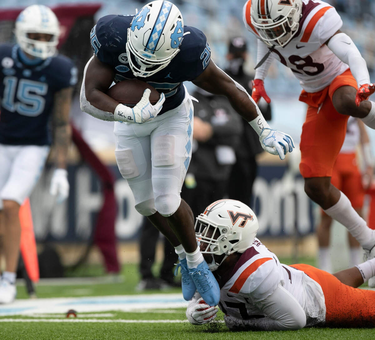 North Carolina’s Javonte Williams (25) breaks away from Virginia Tech’s Rayshard Ashby (23) on a 19-yard run for a touchdown to give the Tar Heels’ a 21-0 lead on Saturday, October 10, 2020 at Kenan Stadium in Chapel Hill, N.C.