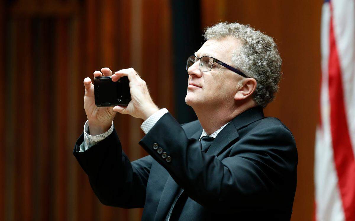 Raleigh council member David Cox takes a photo before the first in-person Raleigh City Council meeting in over a year at the Municipal Building in Raleigh, N.C. Tuesday, June 15, 2021.