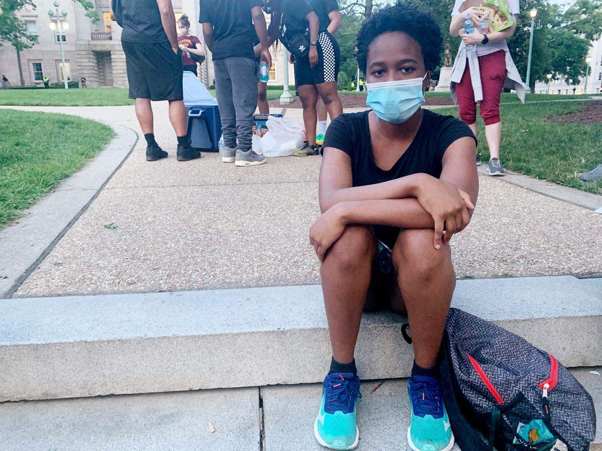 A few dozen people gathered in Moore Square Park for a Christian worship Jordan Sample, 20, sat on the steps next to the confederate statue in front of the Raleigh Capitol building as part of the protests Thursday, June 4, 2020. ÒThis isnÕt mending,Ó she says,Òand until I see justice IÕm going to keep walking.Ó