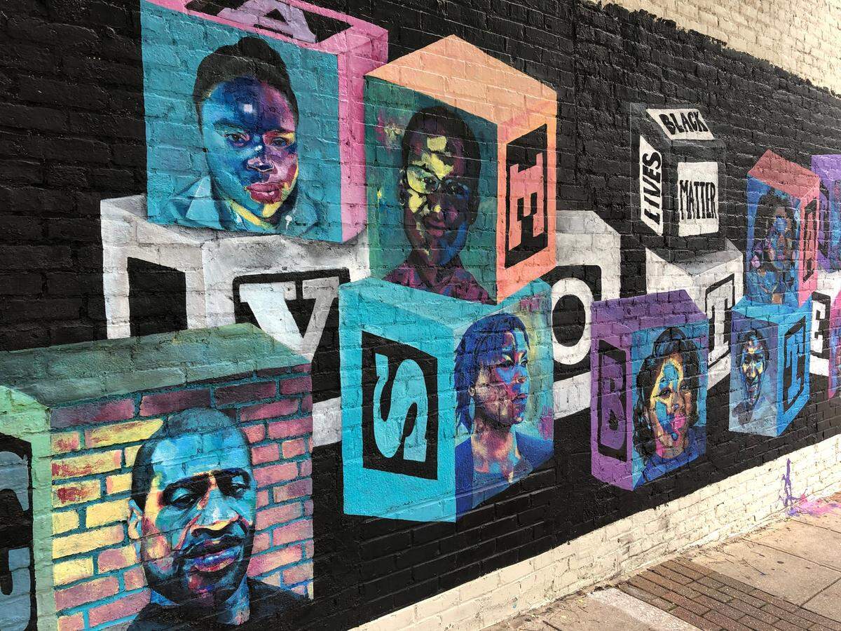 The Untitled Mural at 237 S Wilmington St by Soniya Hardy features Black figures on building blocks with the message “Vote.”