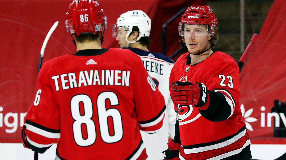 Carolina Hurricanes’ Brock McGinn (23) celebrates his goal with teammate Teuvo Teravainen (86) during the second period of an NHL hockey game against the Columbus Blue Jackets in Raleigh, N.C., Monday, Feb. 15, 2021. (AP Photo/Karl B DeBlaker)