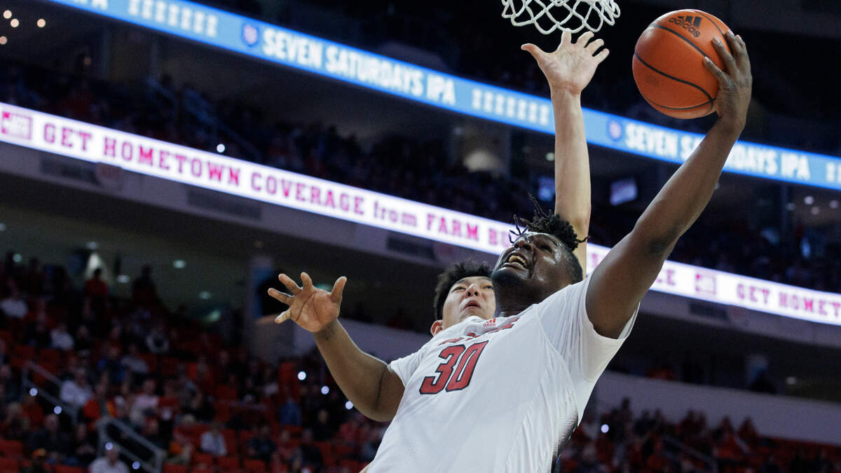 N.C. State’s DJ Burns Jr. drives to the basket past Saint Louis’ Bruce Zhang during the second half of the Wolfpack’s 82-70 win on Wednesday, Dec. 20, 2023, at PNC Arena in Raleigh, N.C.