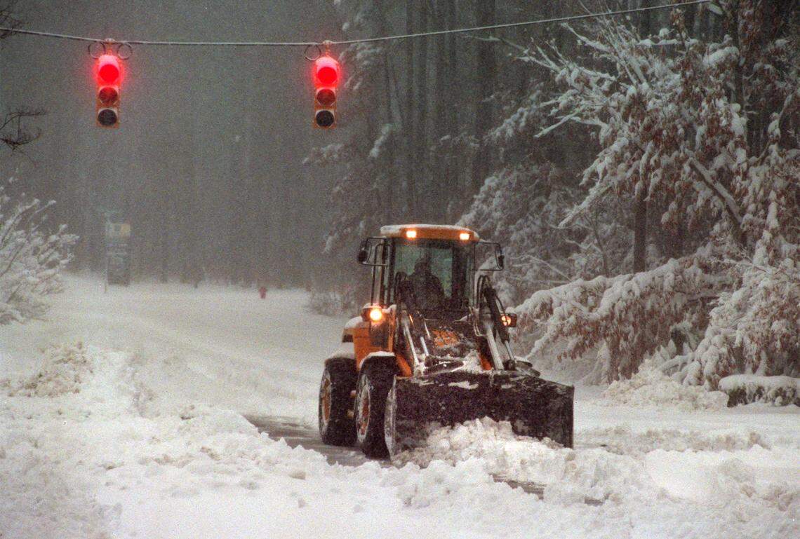 A grader plows snow along Cary Parkway at the intersection of Bebington Drive after two feet of snow fell overnight in 2000.
