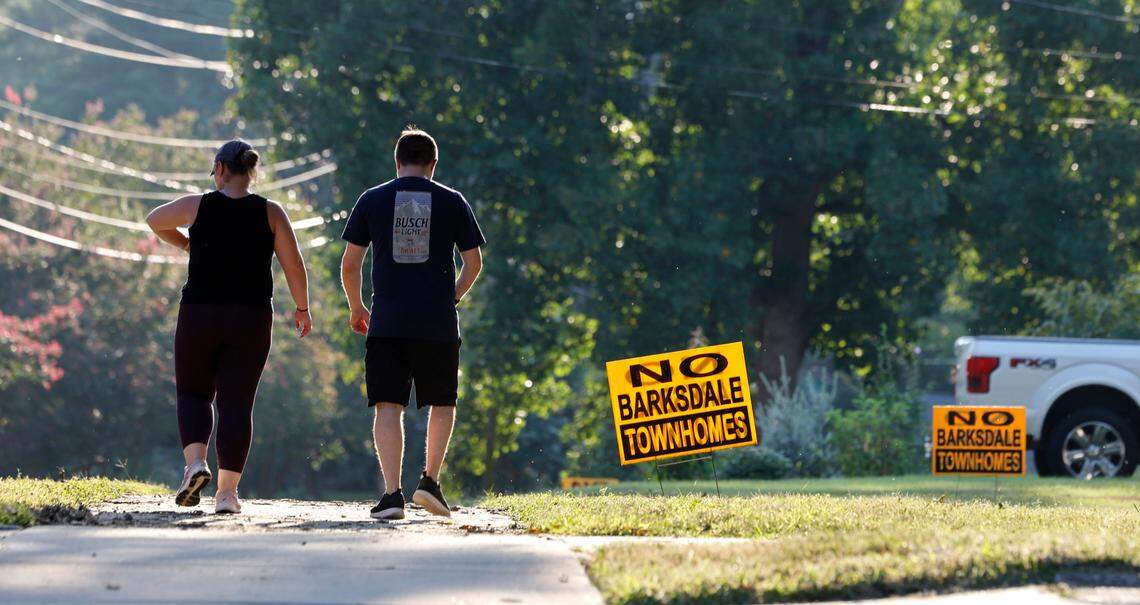 Signs protesting proposed townhomes dot Barksdale Drive in the Woodcrest neighborhood of Raleigh, as seen on Monday, August 26, 2024.