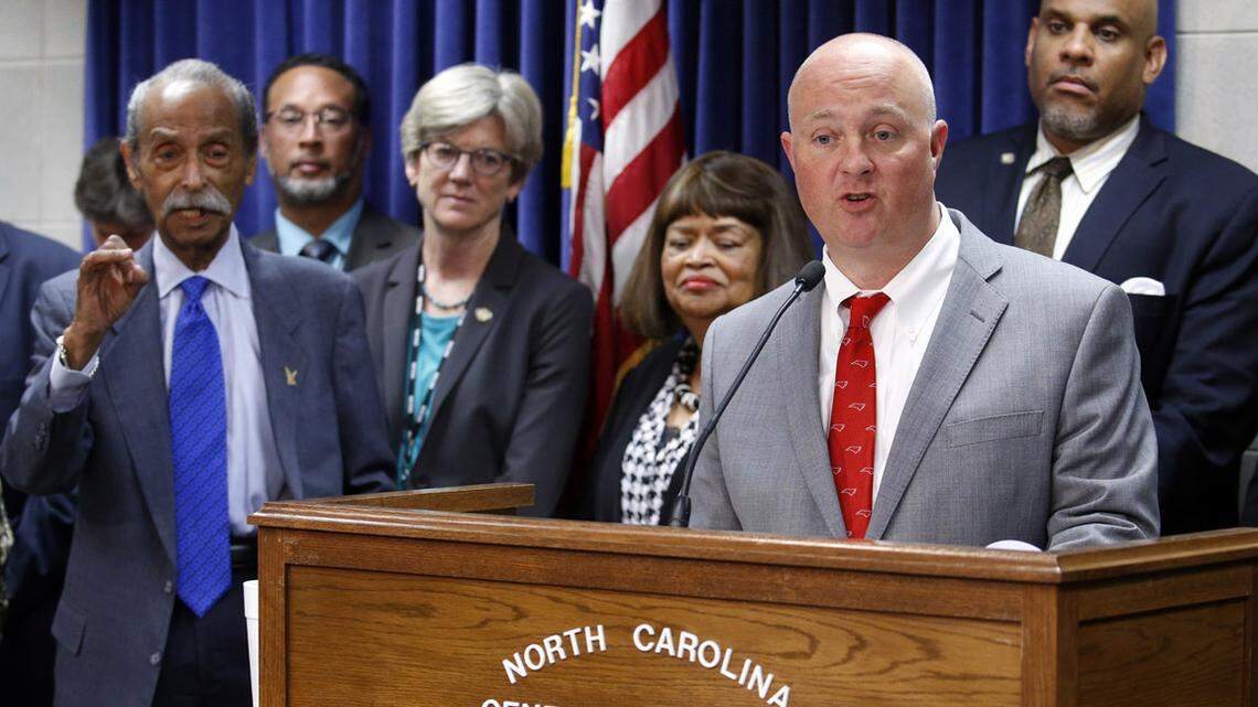 House Democratic leader Darren Jackson, at podium, speaks as several dozen Democrats held a press conference protesting the Republicans budget process at the Legislative Building in Raleigh on May 29, 2018.