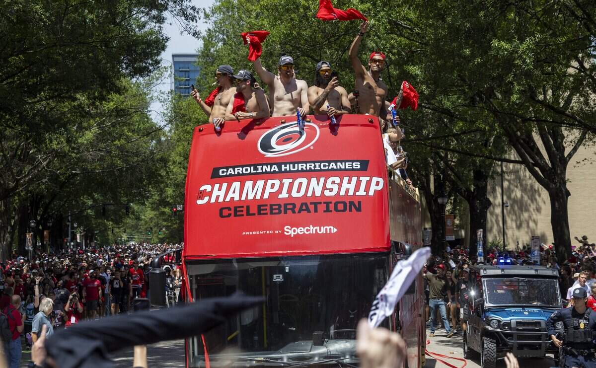 Thousands of Carolina Hurricanes fans gather in downtown Raleigh on Saturday, June 20, 2026, during a parade and rally celebrating the Hurricanes' Stanley Cup Final victory over the Vegas Golden Knights. The Hurricanes won the series 4-2 to capture the Stanley Cup for the second time since 2006.