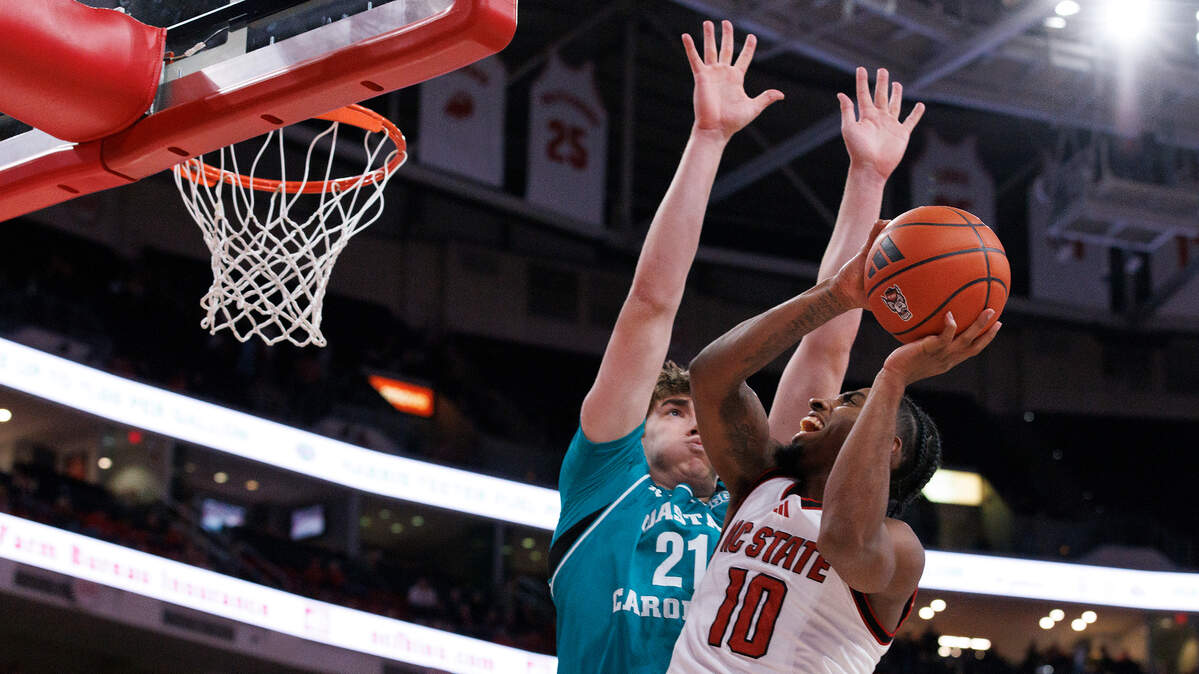 N.C. State’s Marcus Hill drives to the basket past Coastal Carolina’s Noah Amenhauser during the second half of the Wolfpack’s 82-70 win on Wednesday, Nov. 13, 2024, at Lenovo Center in Raleigh, N.C.