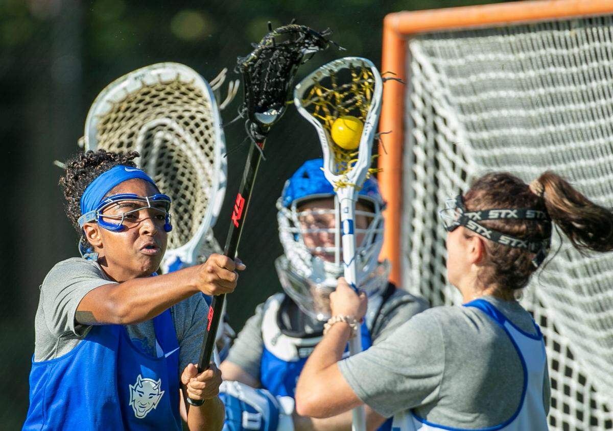 Duke senior Alexis Joseph (1) defends teammate Katie Desimone (4) during lacrosse practice on Thursday, October 14, 2021 in Durham, N.C.