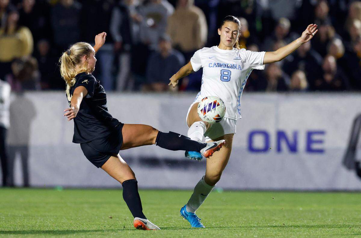 Wake Forest’s Anna Swanson (30) and North Carolina’s Bella Gaetino (8) battle for the ball during the second half of UNC’s 1-0 victory over Wake Forest in the finals of the 2024 Women’s College Cup at WakeMed Soccer Park in Cary, N.C., Monday, Dec. 9, 2024.