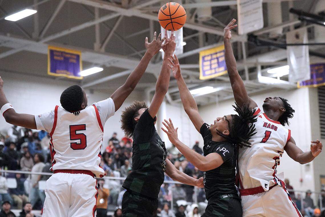 Greenfield's Donovan Dickens (1) and Cameron Moore (14) battle with Coronado's DeVaughn Dorrough (5) and Munir Greig (1) for the rebound during the second half. The Greenfield Knights and the Coronado Cougars (Nevada) met in the finals of the Day'Ron Sharpe bracket of the  John Wall Holiday Tournament in Raleigh, N.C. on December 30, 2025.