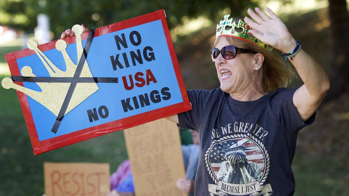 Leslie Russell of Raleigh waves to passing motorists as she joins No Kings protesters on Capitol Blvd. In Raleigh, Saturday, October 18, 2025.