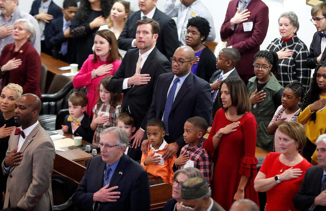 Rep. Sydney Batch, right, with her husband Patrick Williams and sons Mason and Grant, say the Pledge of Allegiance as the N.C. General Assembly convenes in Raleigh, N.C., Wednesday, January 9, 2019.