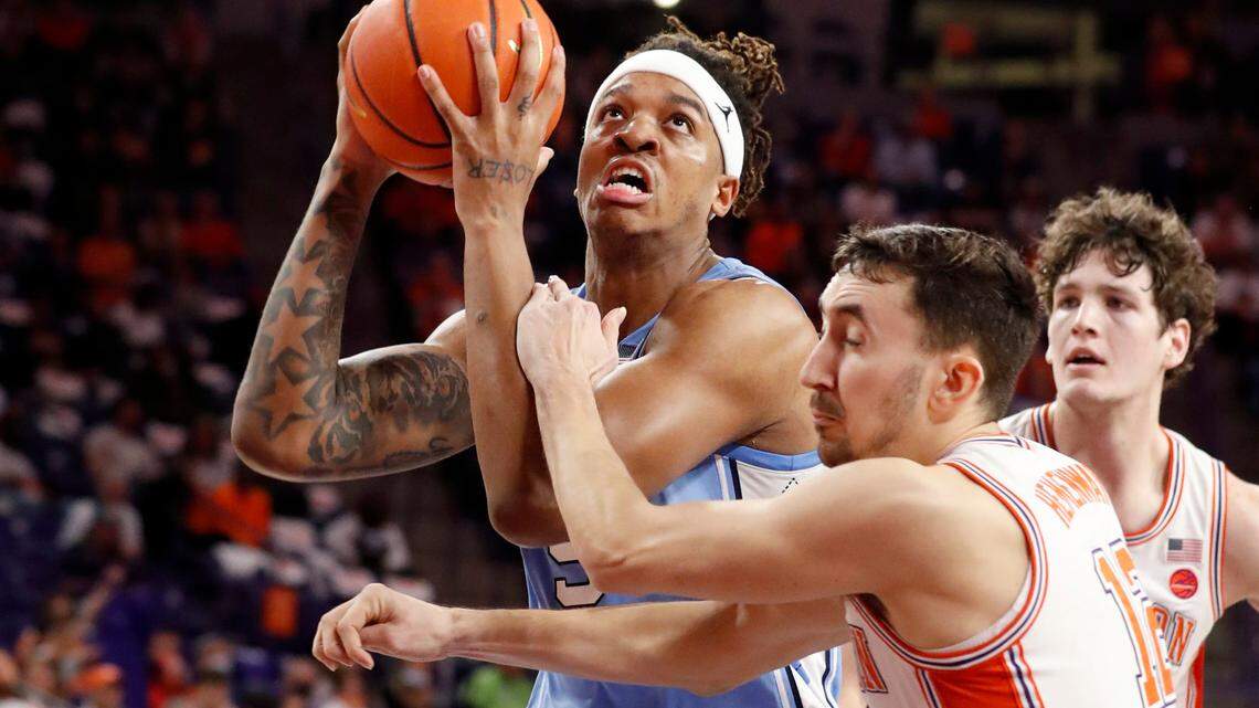 North Carolina’s Armando Bacot (5) is fouled by Clemson’s Alex Hemenway (12) during the second half of UNC’s 79-77 victory over Clemson at Littlejohn Coliseum in Clemson, S.C., Tuesday, Feb. 8, 2022.