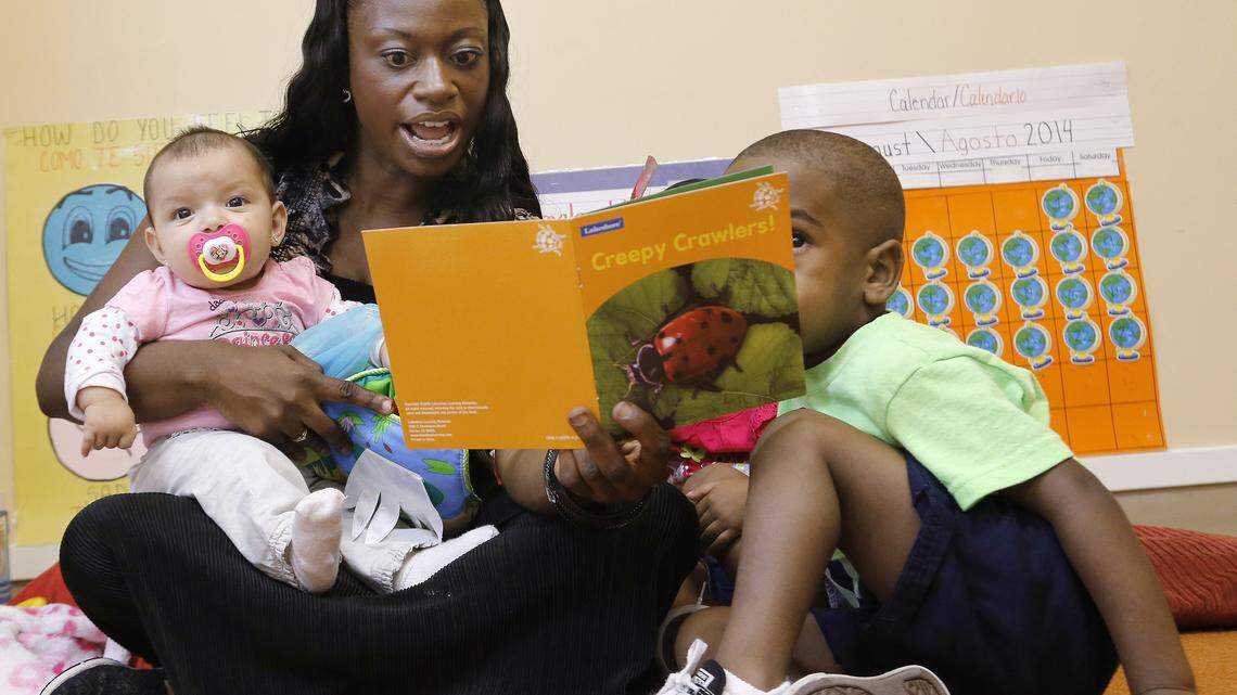 Crystal Wallace, lead teacher at the Child Care Group in Dallas, reads to children on Friday, Aug. 22, 2014. The Child Care Group specializes in educating very young children.