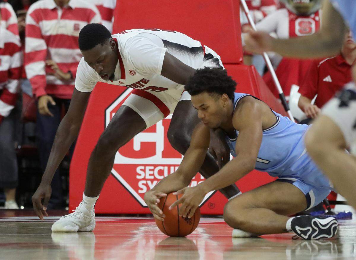 N.C. State’s Mohamed Diarra and The Citadel’s AJ Smith fight for possession during the second half of the Wolfpack’s 72-59 win on Monday, Nov. 6, 2023, at PNC Arena in Raleigh, N.C.