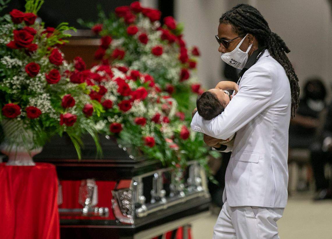 Andrew Brown Jr.’s son Kahlil Ferebee carries his son Carter Ferebee to the alter past Brown’s casket during the funeral at Fountain of Life Church on Monday, May 3, 2021 in Elizabeth City, N.C.