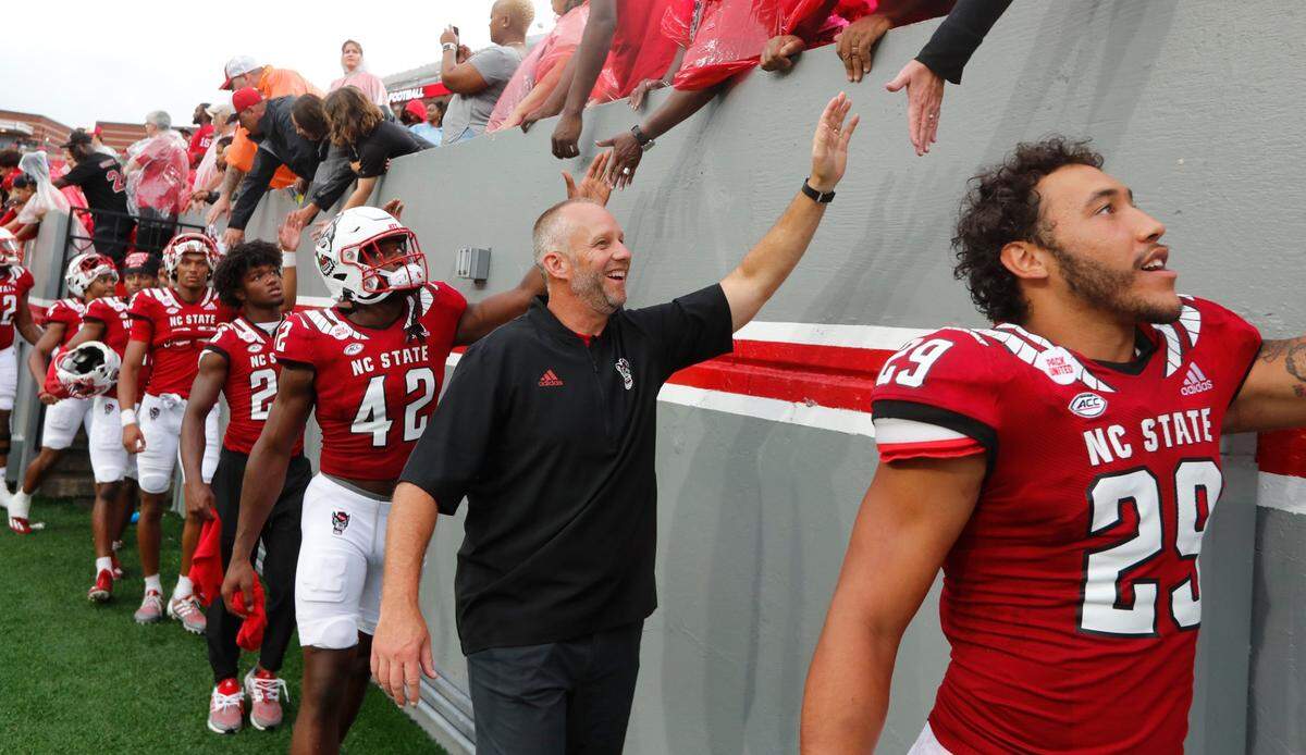 N.C. State head coach Dave Doeren greets fans after N.C. States 55-3 victory over Charleston Southern at Carter-Finley Stadium in Raleigh, N.C., Saturday, Sept. 10, 2022.