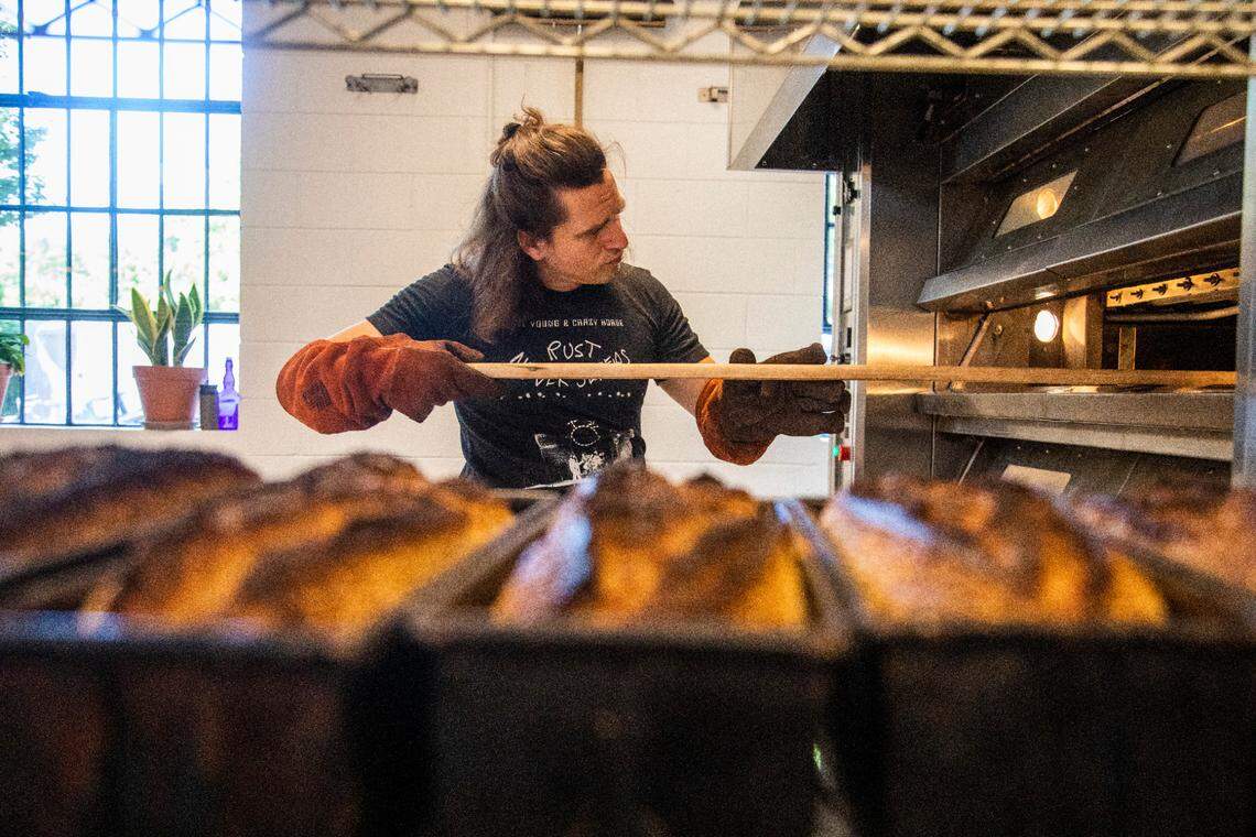 Co-owner Joshua Bellamy bakes sesame pan loafs at Boulted Bread’s new location on Dupont Circle in Raleigh on Friday, May 12, 2023.