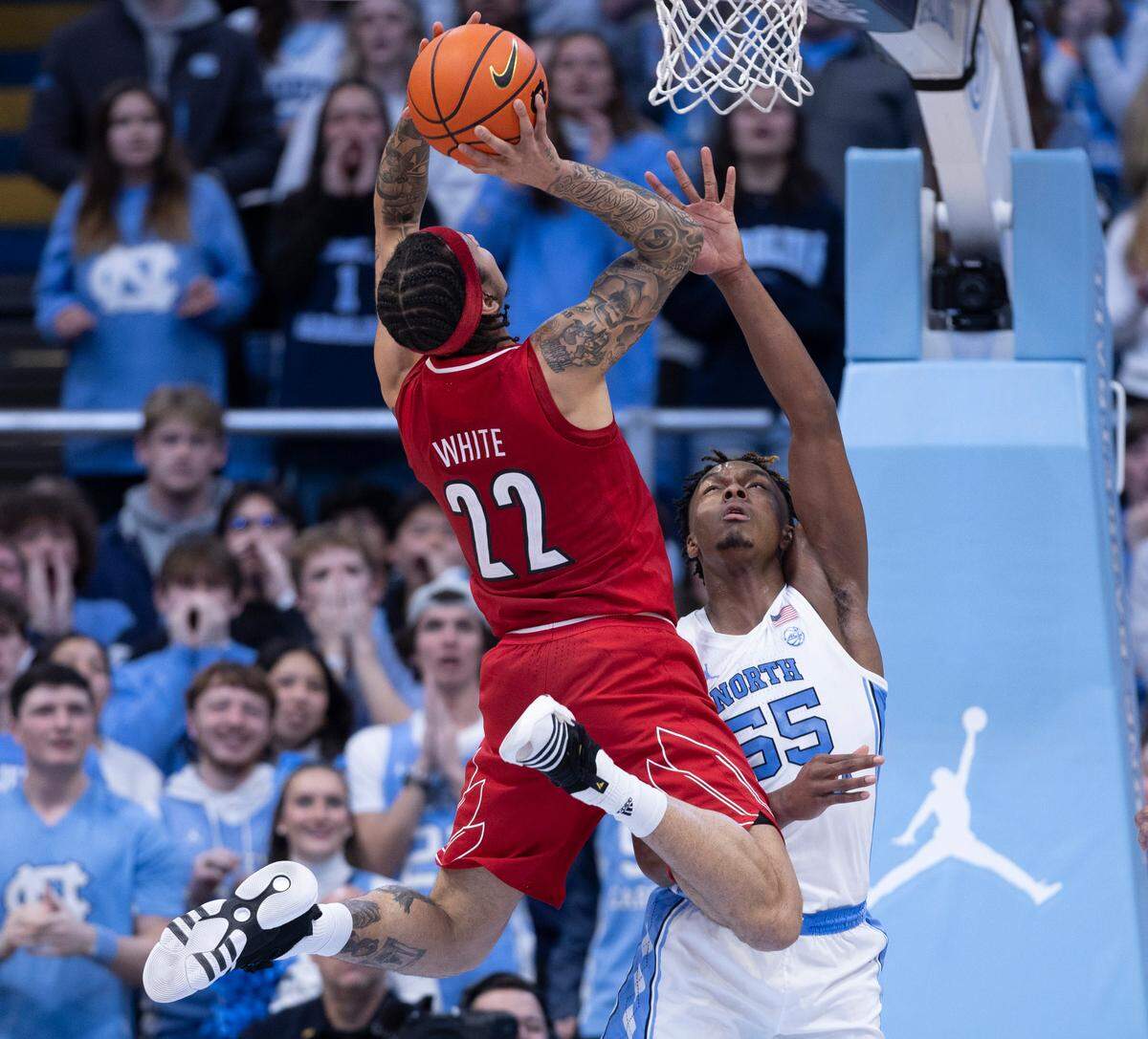 North Carolina’s Harrison Ingram (55) defends Louisville’s Tre White (22) in the first half on Wednesday, January 17, 2024 at the Smith Center in. Chapel Hill, N.C.