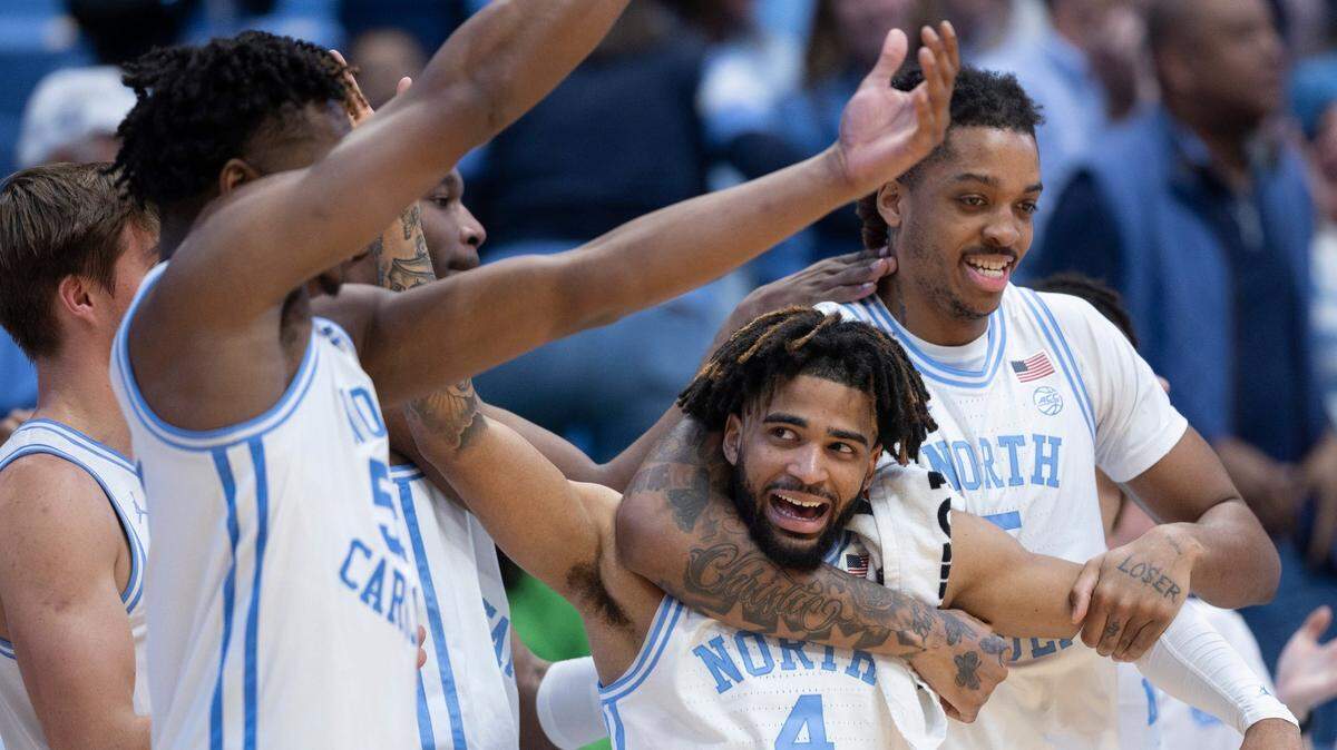 North Carolina’s Armando Bacot (5) embraces R.J. Davis (4) as they celebrate their 103-67 victory over Syracuse on Saturday, January 13, 204 at the Smith Center in Chapel Hill, N.C.