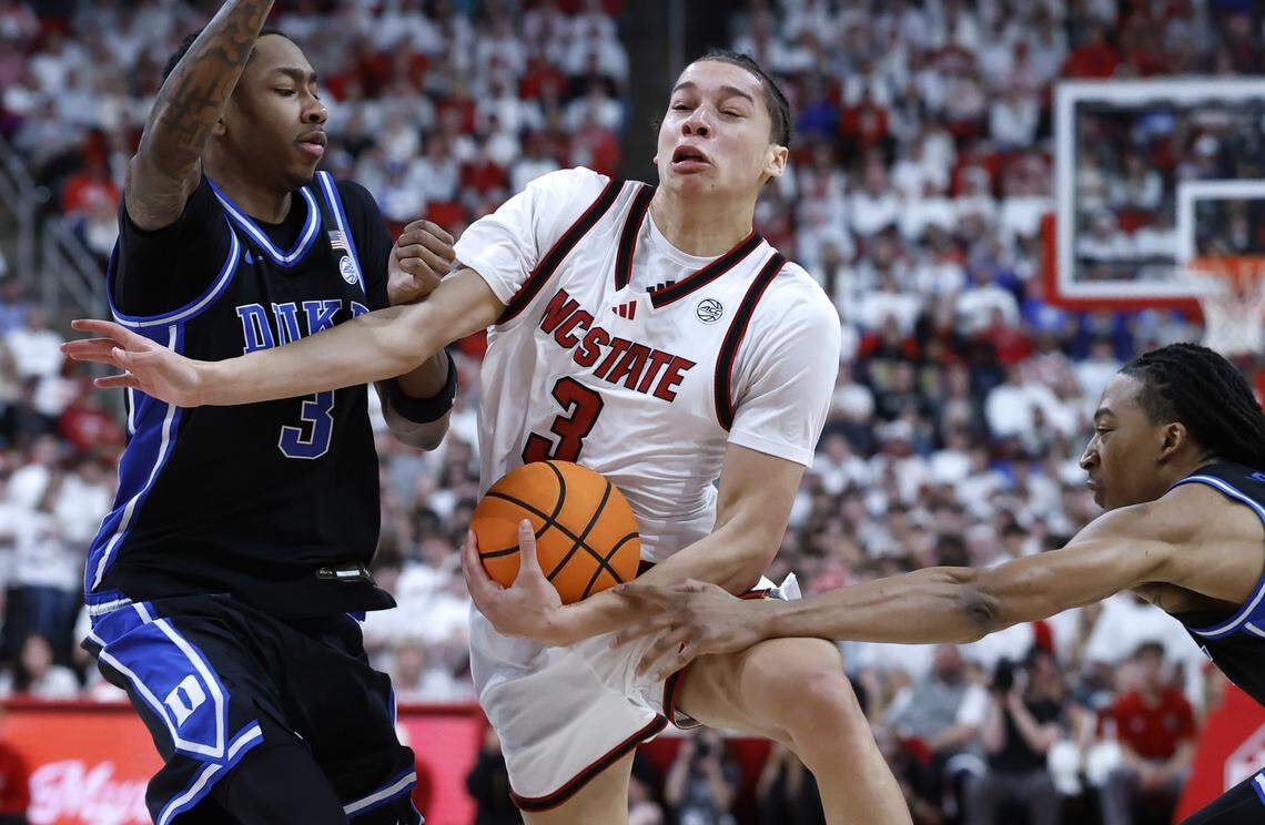 NC State's Matt Able (3) drives by Duke’s Isaiah Evans (3) and Maliq Brown (6) during the first half of Duke’s game against N.C. State at the Lenovo Center in Raleigh, N.C., Monday, March 2, 2026.
