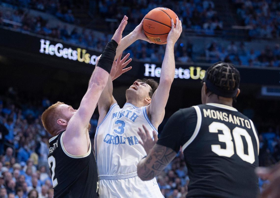 North Carolina’s Cormac Ryan (3) puts up a shot against Wake Forest’s Cameron Hildreth (2) during the first half on Monday, January 22, 2024 at the Smith Center in Chapel Hill, N.C.
