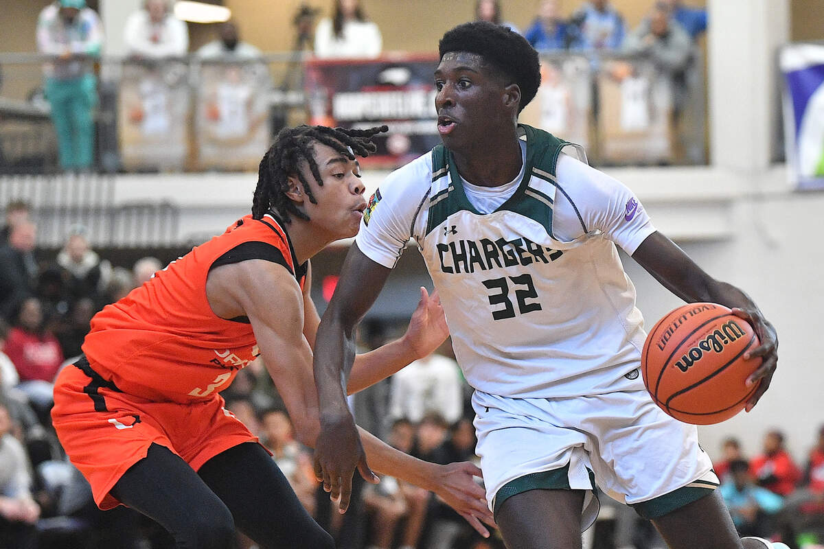 Northwood’s Drake Powell (32) drives past Orange’s Freddy Sneed (3) in the first half at the John Wall Holiday Invitational. The Northwood Chargers and the Orange Panthers met in the John Wall Holiday Invitational in Raleigh, N.C. on December 28, 2023.