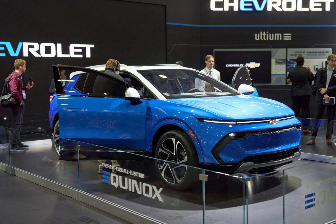 Members of the media look at the Chevy Equinox EV at the North American International Auto Show in Detroit, Michigan on September 14, 2022.