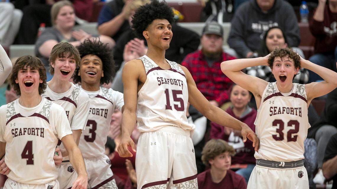 Seaforth High School’s Cooper Jones (4), Declan Lindquist (23), Noah Lewis (3), Jarin Stevenson (15) and Brandon Sturdivant (32) react after a basket by a reserve player in the closing minutes of their 75-48 victory over Graham High School on January 13, 2023 in Pittsboro, N.C.