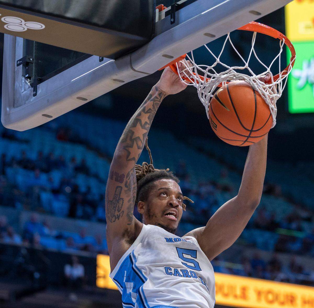 North Carolina’s Armando Bacot (5) gets dunk for two of his 13 points in the first half against St. Augustine on Friday, October 27, 2023 at the Smith Center in Chapel Hill, N.C.