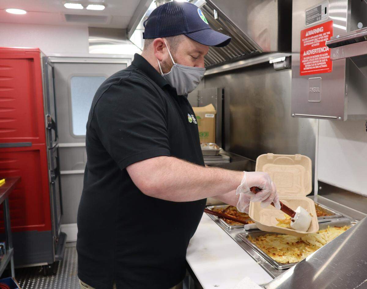 Food Truck Manager Josh Maple serves up a meal on The Spinning Plate. The Spinning Plate food truck is Inter-Faith Food Shuttle’s newest hunger fighting initiative. It addresses hunger in neighborhoods in the Raleigh area by bringing free hot meals to the places that need them most.
