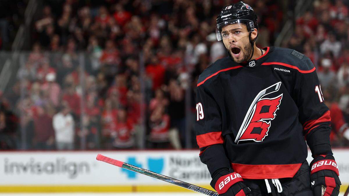 K'Andre Miller of the Carolina Hurricanes celebrates following a goal scored during the third period of the game against the New Jersey Devils at Lenovo Center on October 09, 2025 in Raleigh, North Carolina.