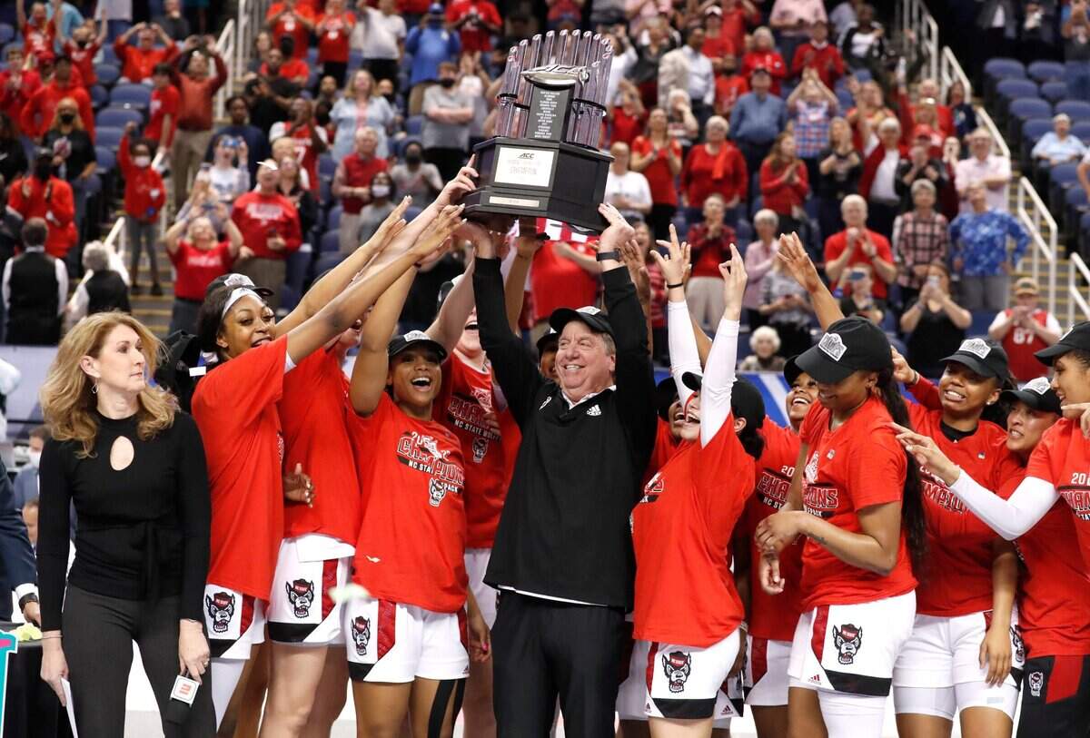 N.C. State head coach Wes Moore raises the championship trophy after N.C. States 60-47 victory over Miami to win the ACC womens basketball tournament in Greensboro, N.C., Sunday, March 6, 2022.