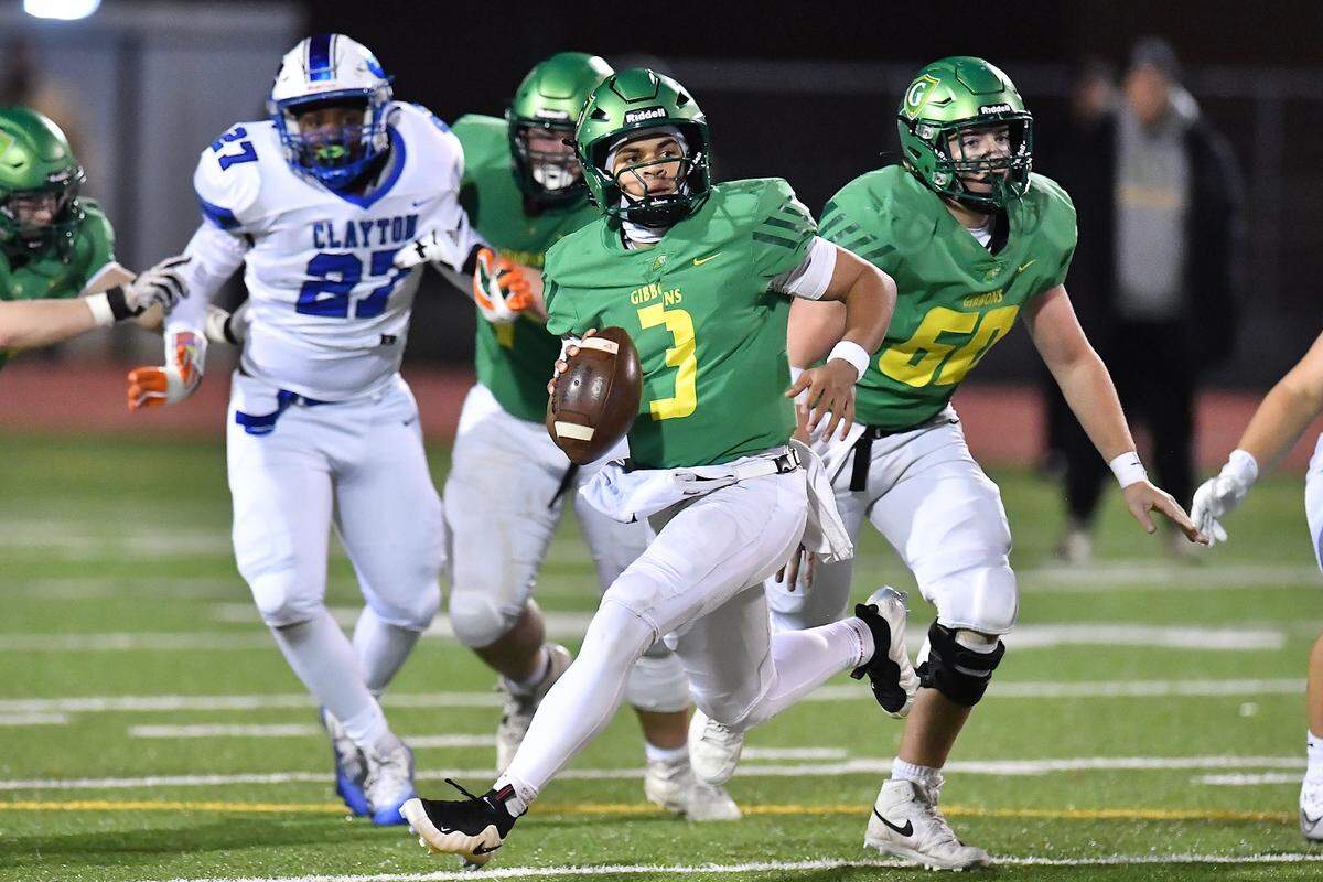 Cardinal Gibbons quarterback Gannon Jones looks to pass downfield to an open player against Clayton in the final seconds of the NCHSAA 7A East Regional Final. The Clayton Comets and the Cardinal Gibbons Crusaders met in the East Regional Final of the NCHSAA 7A Football Championship in Clayton, N.C. on December 4, 2025.