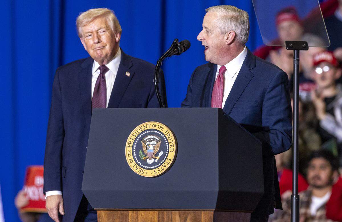 President Donald Trump and former Republican National Committee chair and Republican U.S. Senate primary candidate Michael Whatley speak on stage during a rally at the Rocky Mount Event Center in Rocky Mount on Friday, Dec. 19, 2025. Trump endorsed Whatley in July.