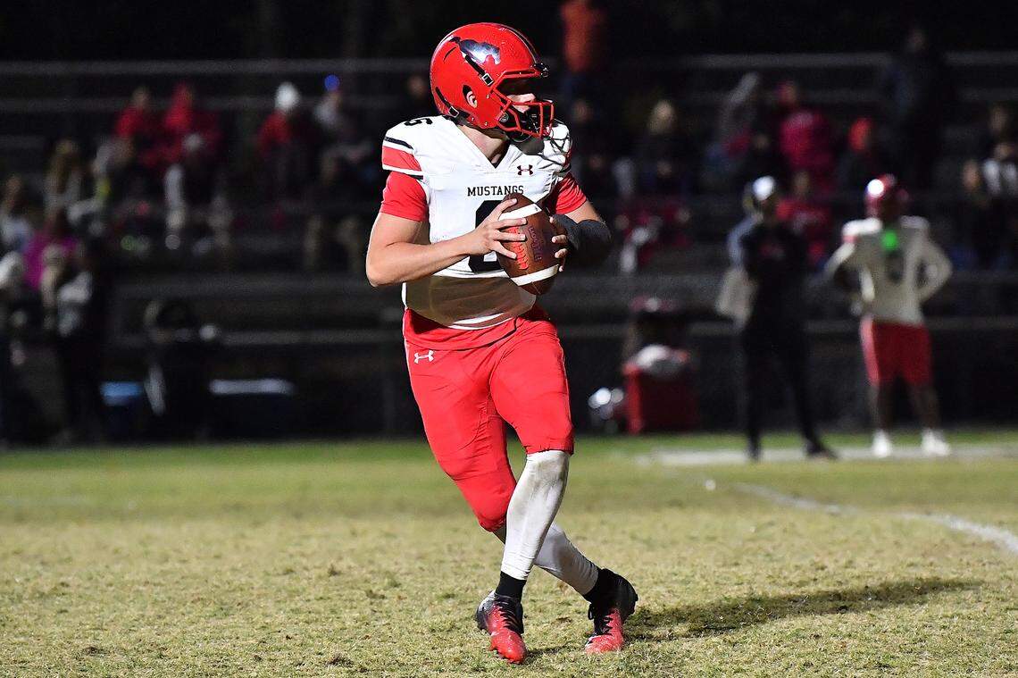 Middle Creek quarterback Lex Sevilla (6) looks to pass downfield against Cary during the first half. The Cary Imps and the Middle Creek Mustangs met in a conference football game in Cary, N.C. on October 24, 2025