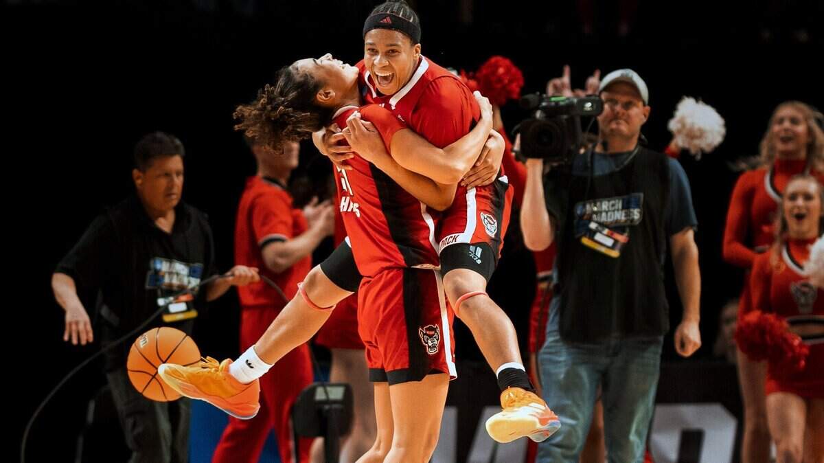 NC State’s Zoe Brooks leaps into the arms of Madison Hayes after defeating Stanford in their NCAA Sweet 16 game in Portland.