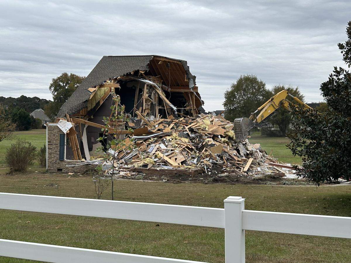 The house is torn down on Rand Road near Garner four months after a murder-suicide there that killed Shannon Collins, 49, and his two sons, 13-year-old Jet and 15-year-old River.