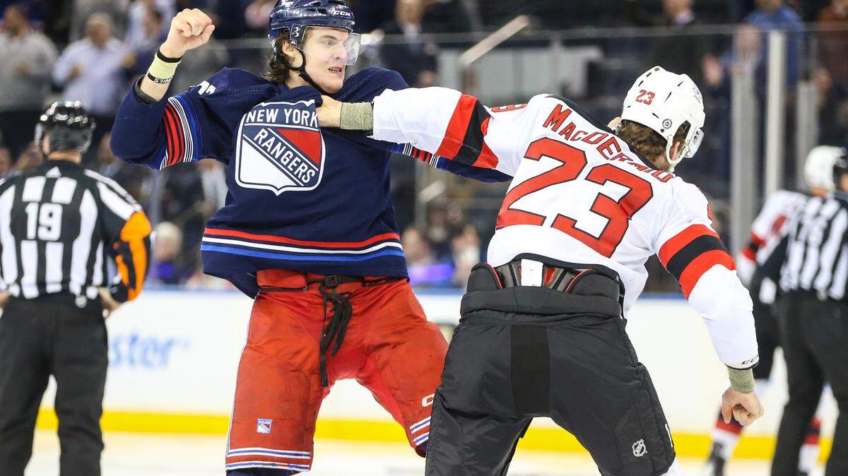 Apr 3, 2024; New York, New York, USA; New York Rangers center Matt Rempe (73) and New Jersey Devils defenseman Kurtis MacDermid (23) fight at start of the 1st period at Madison Square Garden. Mandatory Credit: Wendell Cruz-USA TODAY Sports