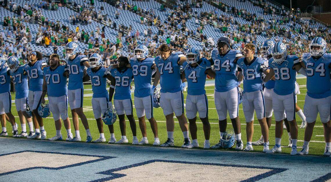 With the stadium nearly empty, the North Carolina football team stands together for the Alma Mater following their 45-32 loss to Notre Dame on Saturday, September 24, 2022 at Kenan Stadium in Chapel Hill, N.C.