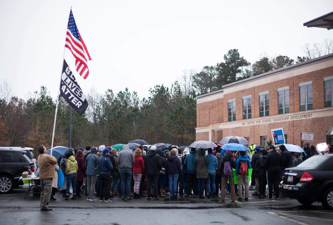 Protesters demonstrate outside the Board of Governors meeting against a proposed plan to build a $5.3 million center to house Silent Sam on Friday morning, Dec. 14, 2018.