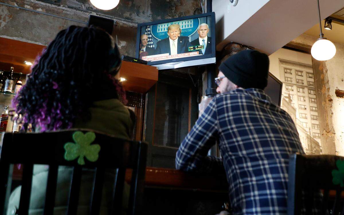Andi Savary, left, and her best friend, Bryan David Blythe, have lunch at The Raleigh Times in Raleigh, N.C., Tuesday, March 17, 2020. Gov. Roy Cooper ordered bars and restaurants to close at 5 p.m. Tuesday, except for take-out and delivery. The Raleigh Times will offer curbside pickup and delivery via DoorDash.