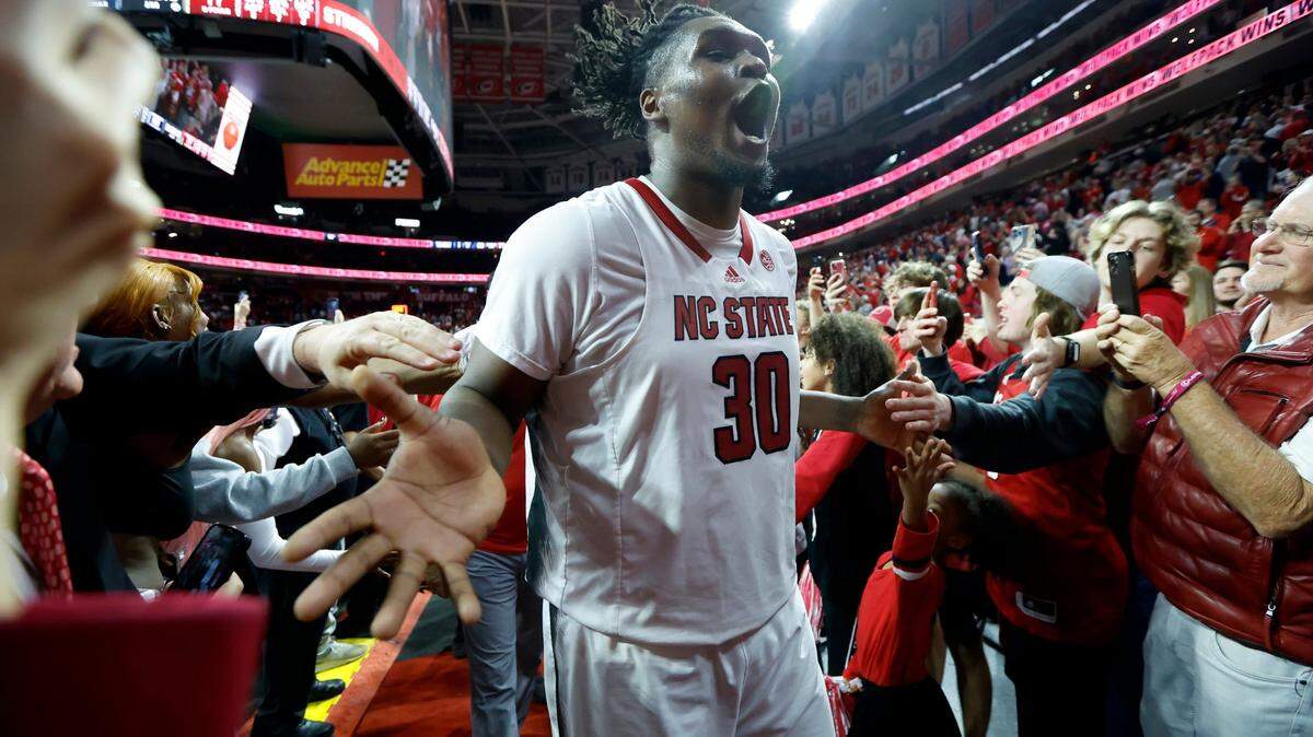 N.C. State’s D.J. Burns Jr. (30) celebrates as he comes off the court after N.C. State’s 77-69 victory over UNC at PNC Arena in Raleigh, N.C., Sunday, Feb. 19, 2023.