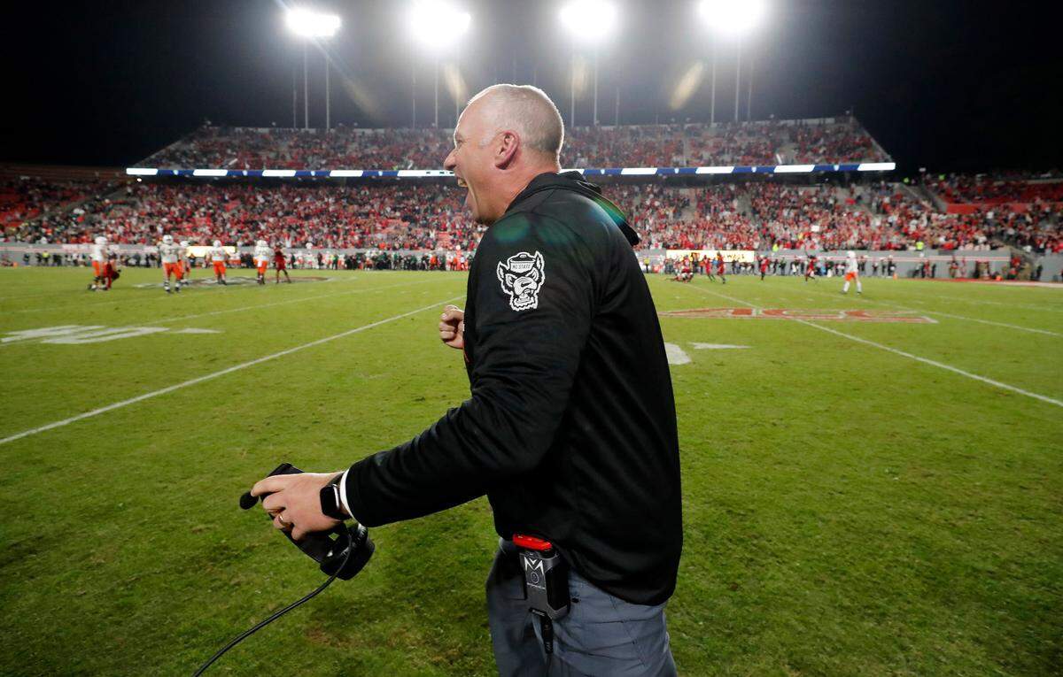 N.C. State head coach Dave Doeren celebrates as time runs out in the Wolfpack’s 20-6 victory over Miami at Carter-Finley Stadium in Raleigh, N.C., Saturday, Nov. 4, 2023. The victory makes Doeren the Pack’s the winningest coach in N.C. State history.