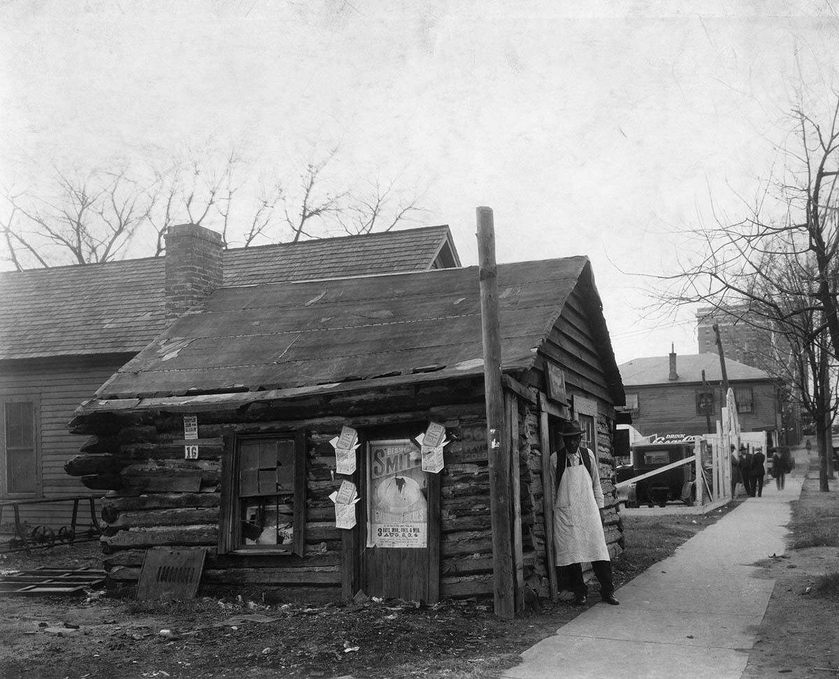 This shoemaker on East Davie Street in 1926 is playing no part in Raleigh’s red light district, but the surroundings show what the general area looked like.