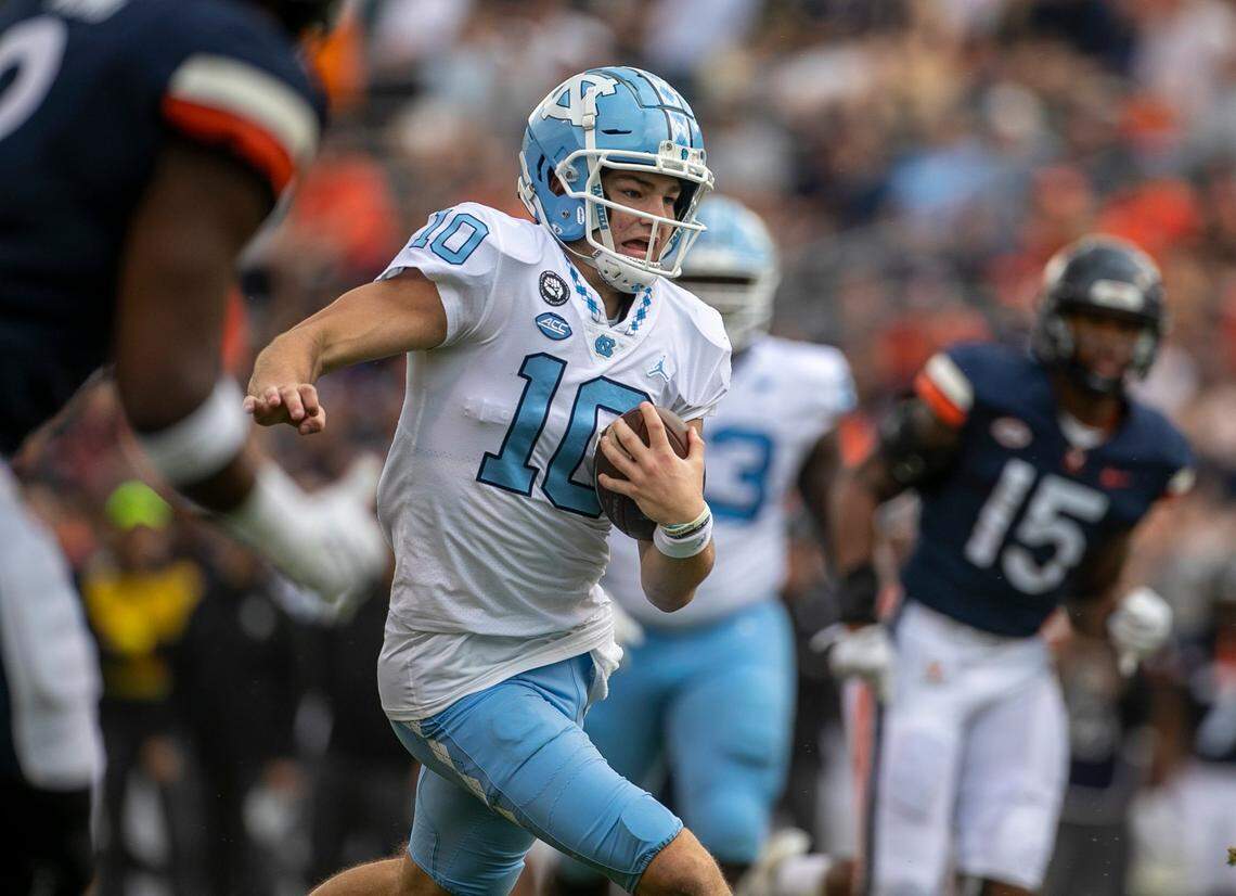 North Carolina quarterback Drake Maye (10) breaks through the Virginia defense on a 26-yard run in the first quarter on Saturday, November 5, 2022 at Scott Stadium in Charlottesville, Va.