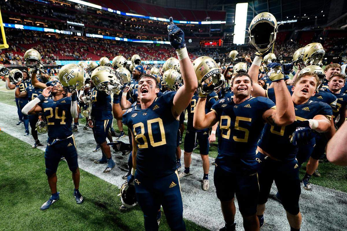 Georgia Tech’s Dylan Leonard (80), Billy Ward (85) and Ben Wilhelm (87) sing “Ramblin Wreck” after defeating North Carolina in an NCAA college football game Saturday, Sept. 25, 2021, in Atlanta.